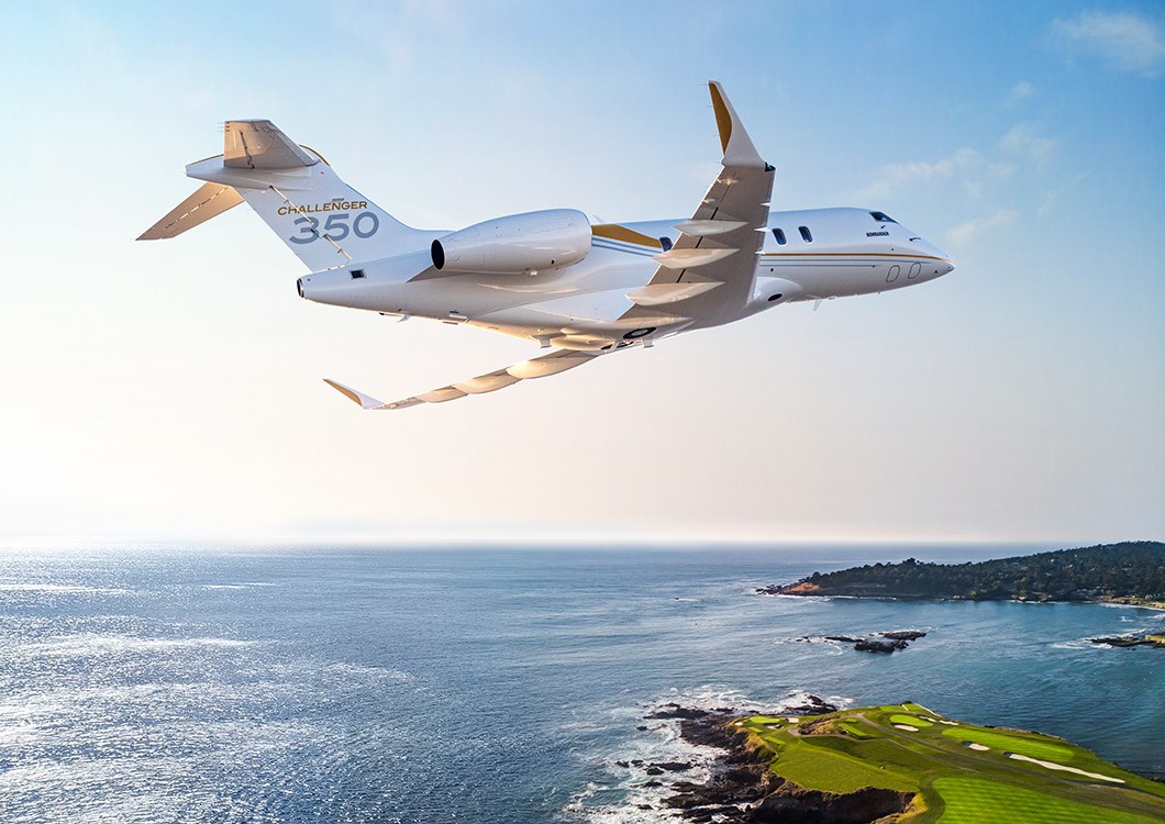 Bombardier Challenger 350 super-midsize jet over coastline