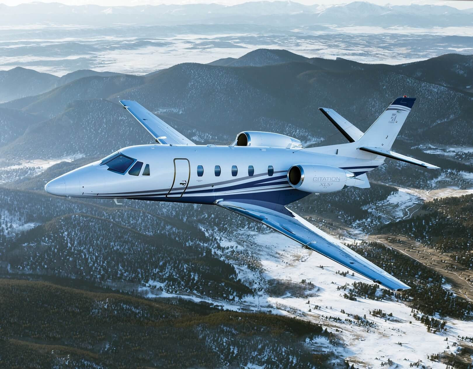 Cessna Citation XLS+ in flight over mountains