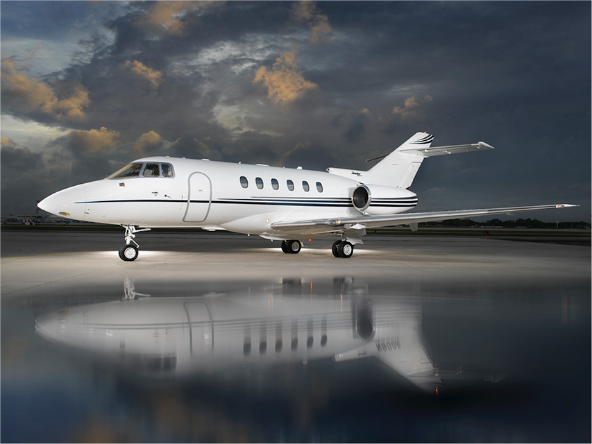 Hawker 800XP midsize jet on ramp at dusk
